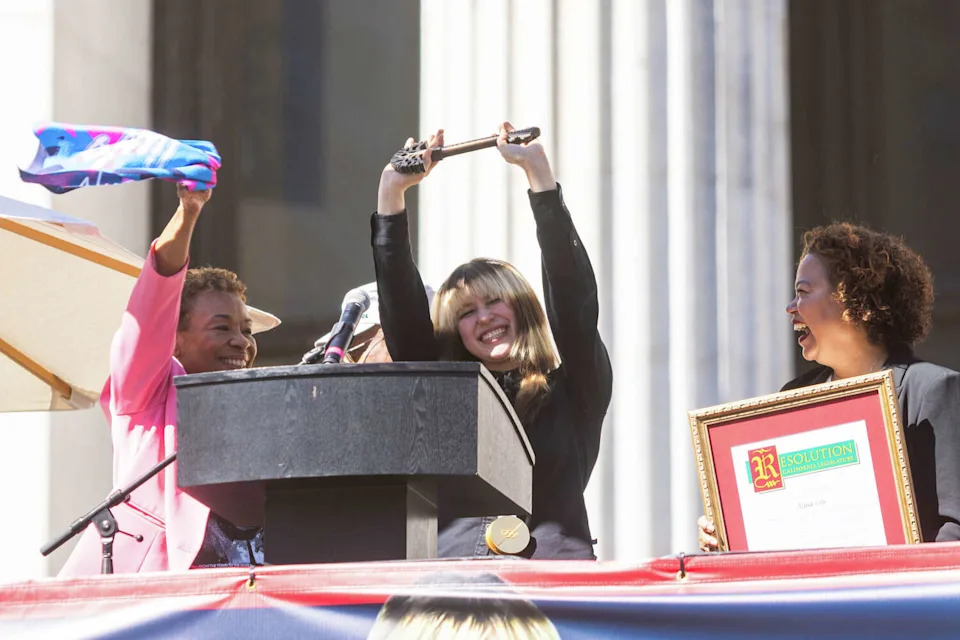 Olympic figure skating gold medalist Alysa Liu holds up the ceremonial key to Oakland during the Alysa Liu Celebration Rally at Frank Ogawa Plaza in front of Oakland City Hall in Oakland, Calif., on March 12, 2026. (Douglas Zimmerman/SFGATE)