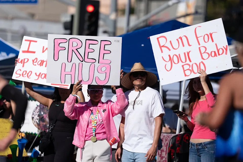 Spectators hold signs along the course during the Los Angeles Marathon on Sunday, March 8, 2026, in Los Angeles.