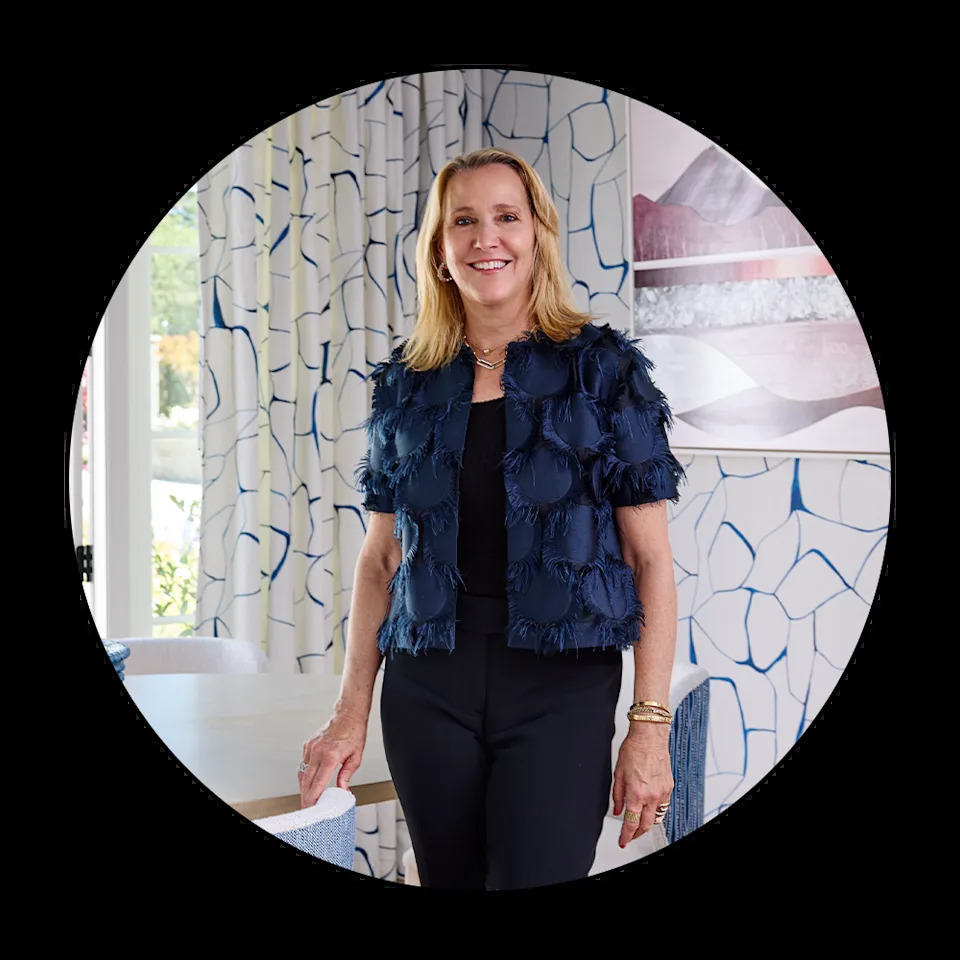 Woman standing in an interior space with modern decor.
