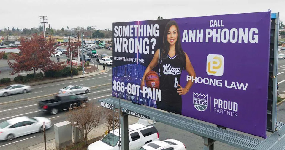 Vehicles drive past one of attorney Anh Phoong’s ubiquitous billboards, emblazoned with her “Something wrong?” tagline and touting her connection with the Sacramento Kings, on Arden Way in 2024.