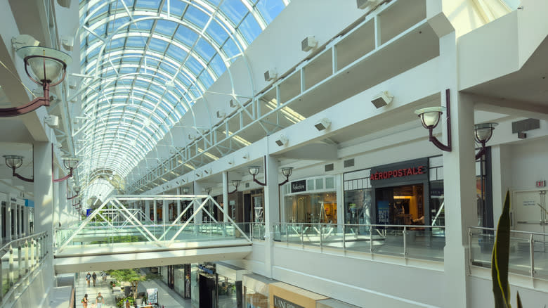 Arden Fair mall's two -story building with large skylights in the ceiling.