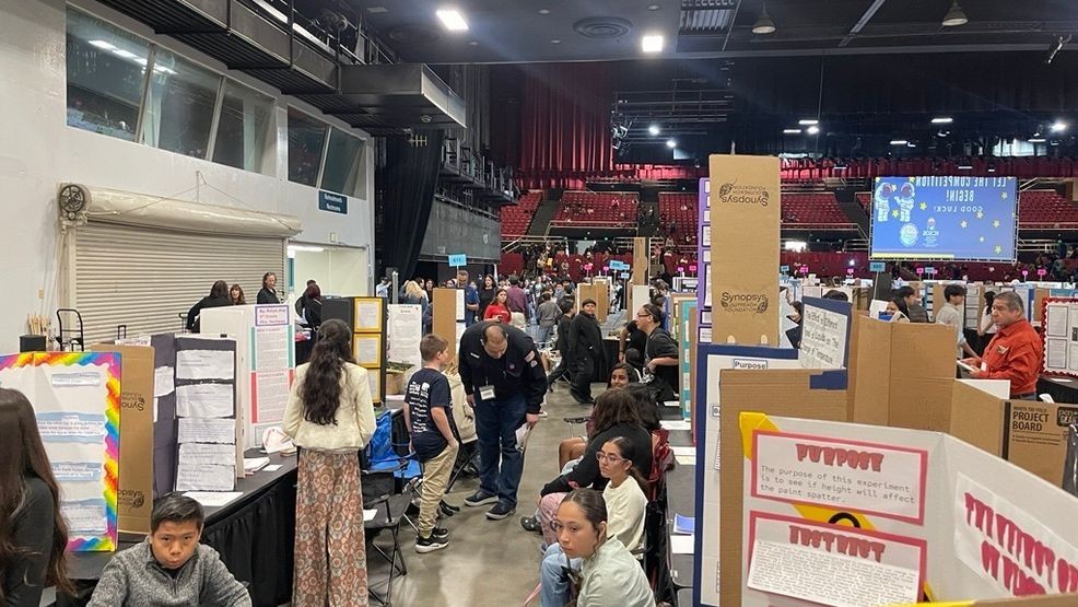 Fourth through sixth grade students sit alongside their science projects at the annual KCSOS Science Fair PHOTO: KBFX{p}{/p}{p}{/p}