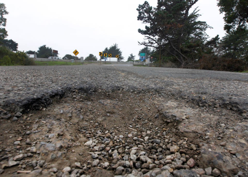 A series of deep potholes are hazardous for vehicles on Potter Street leading to the on-ramp of eastbound I-80 on the south end of Aquatic Park in Berkeley, Calif. San Francisco Chronicle via Getty Images