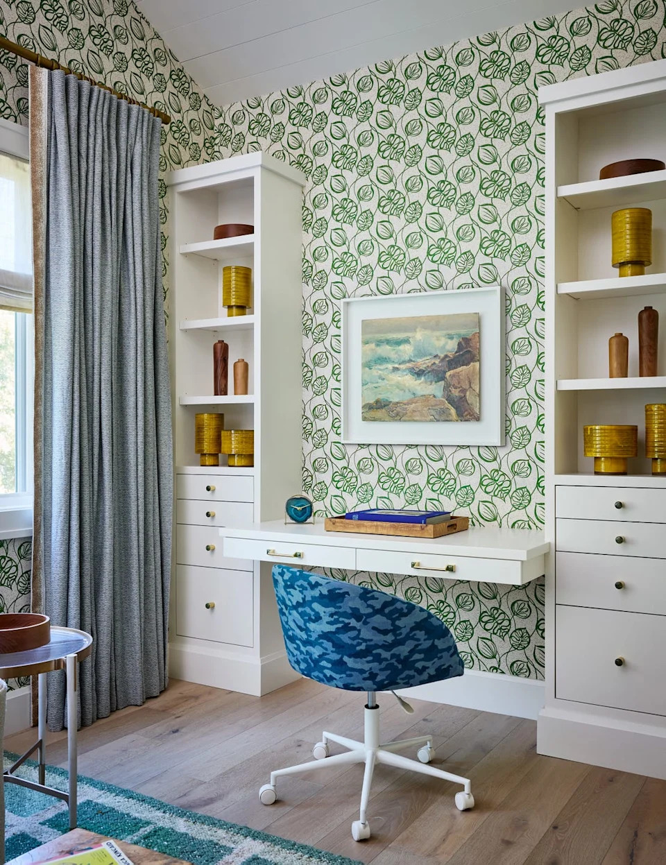 Home office setup with modern decor and floral wallpaper
