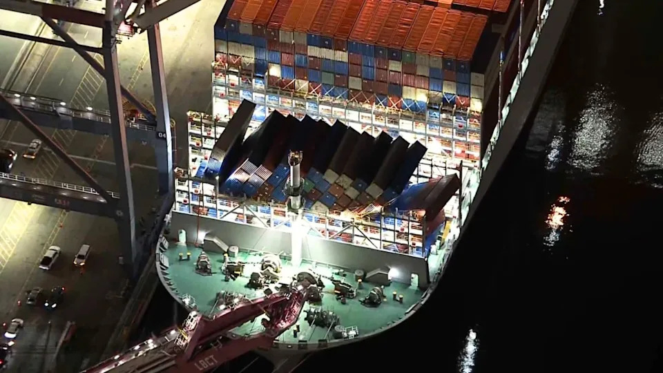 Containers dangle from cargo ship in Port of Long Beach
