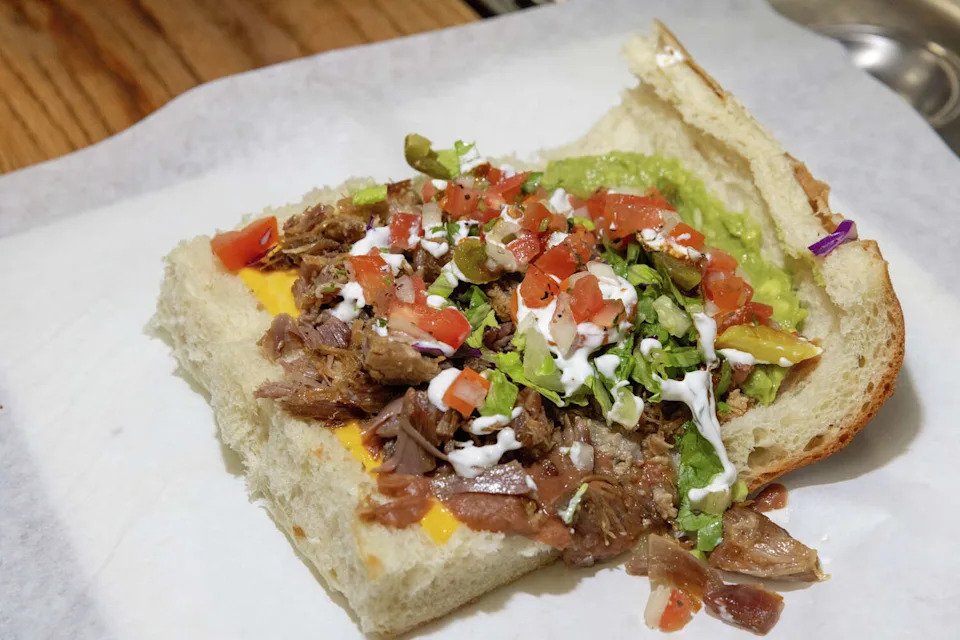 A carnitas torta, one of the specialties of the taqueria inside Don Chuy's Mexi-Mercado, a corner store in the Excelsior District of San Francisco, on Feb. 25, 2026. (Douglas Zimmerman/SFGATE)