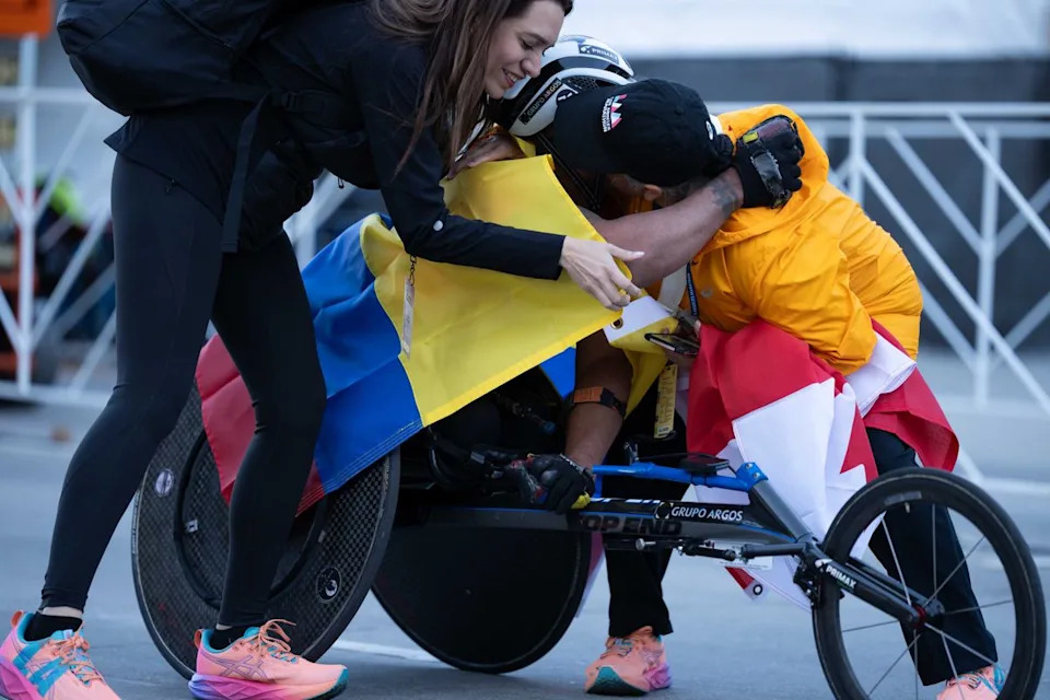 Francisco Sanclemente of Colombia is greeted by supporters after finishing the Los Angeles Marathon on Sunday, March 8, 2026, in Los Angeles.