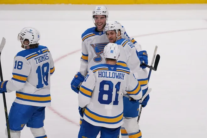 Mar 6, 2026; San Jose, California, USA; St. Louis Blues defenseman Philip Broberg (6) celebrates with center Jack Finley (37), left winger Dylan Holloway (81) and center Robert Thomas (18) after the game-winning goal against the San Jose Sharks in overtime at SAP Center at San Jose.
