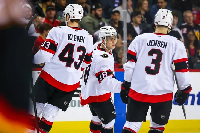 Mar 5, 2026; Calgary, Alberta, CAN; Ottawa Senators center Tim Stützle (18) celebrates his goal with teammates against the Calgary Flames during the third period at Scotiabank Saddledome.