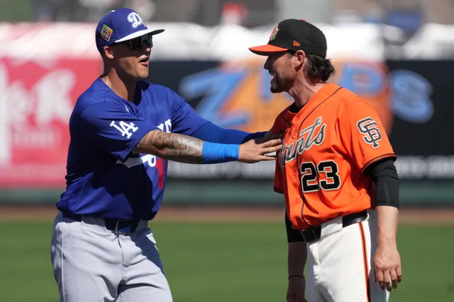 Feb. 27, 2026; Scottsdale, Arizona; Los Angeles Dodgers third baseman Nick Senzel (15) talks to San Francisco Giants manager Tony Vitello (23) before a game at Scottsdale Stadium.