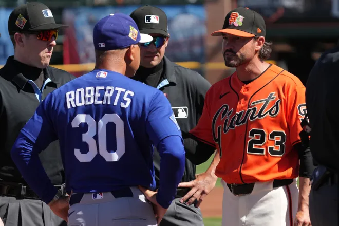 Feb. 27, 2026; Scottsdale, Arizona; Los Angeles Dodgers manager Dave Roberts (30) talks to San Francisco Giants manager Tony Vitello (23) before a game at Scottsdale Stadium.