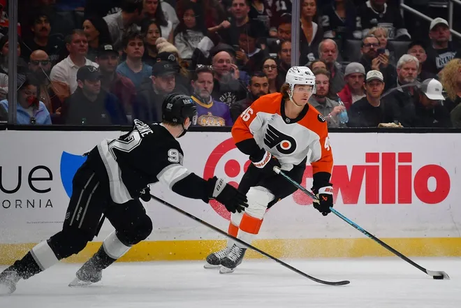 Mar 19, 2026; Los Angeles, California, USA; Philadelphia Flyers center Trevor Zegras (46) controls the puck against Los Angeles Kings defenseman Brandt Clarke (92) during the third period at Crypto.com Arena.