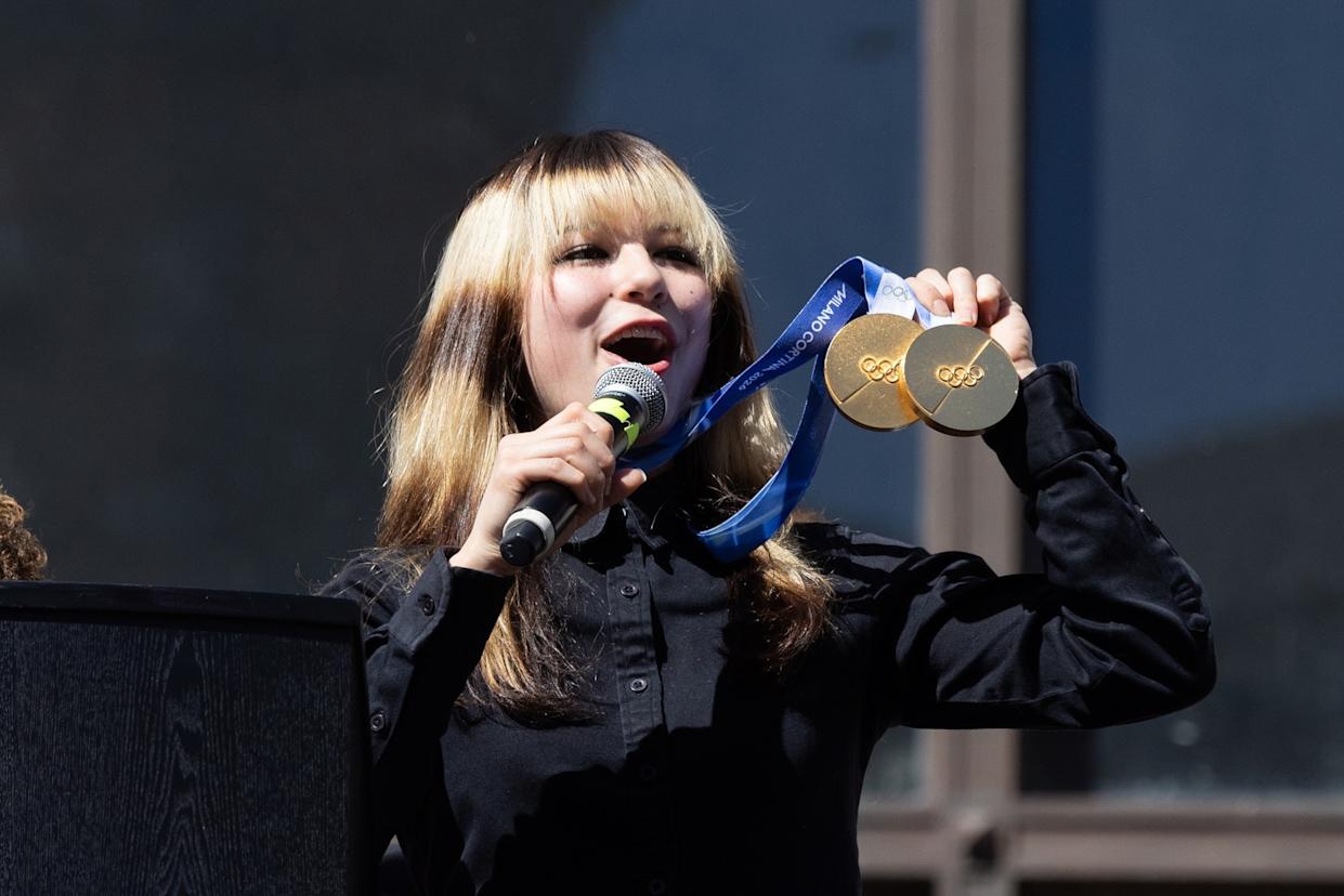 Benjamin Fanjoy/Getty Images - PHOTO: Olympic gold medalist Alysa Liu holds two gold medals during a rally celebrating her accomplishments at the Milano Cortina 2026 Olympics, on March 12, 2026, in Oakland, Calif.