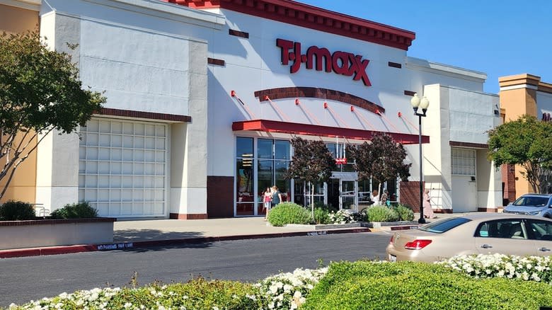 The white and red facade of TJ Maxx with flowers and trees planted in the parking lot at Sacramento gateway mall.
