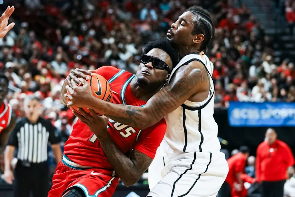 New Mexico guard Deyton Albury (1) attempts to drive through San Diego State Reese Dizon-Waters (39) during semifinal Mountain West Championship tournament game between San Diego State and New Mexico on Friday March 13, 2026 in Las Vegas, Nev.
