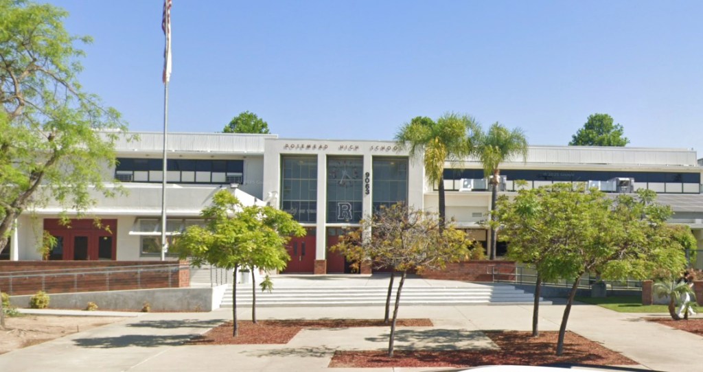 Front exterior of Rosemead High School, a white two-story building with a sign that reads "Rosemead High School" above the entrance.