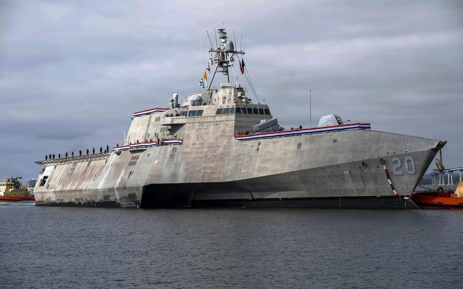 A Navy ship transits through the water.