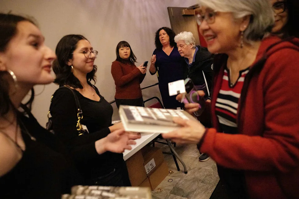 Attendees receive free copies of Gov. Gavin Newsom's book, "Young Man in a Hurry." (Manuel Orbegozo/For the S.F. Chronicle)