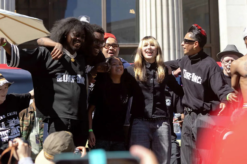 Olympic Gold Medalist Alysa Liu (second from right) joins the TURFinc dance performance during the Alysa Liu Celebration Rally at Frank Ogawa Plaza in front of Oakland City Hall in Oakland, Calif., on March 12, 2026. (Douglas Zimmerman/SFGATE)