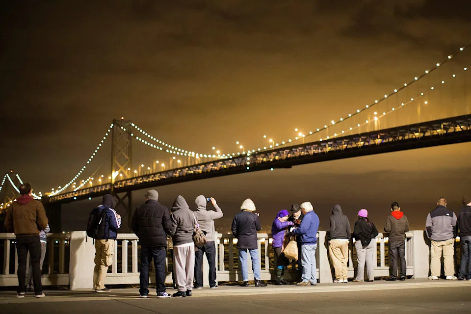 FILE: Spectators watch the grand lighting of the Bay Lights art installation on the San Francisco-Oakland Bay Bridge on March 5, 2013, in San Francisco. (Stephen Lam/Getty Images)