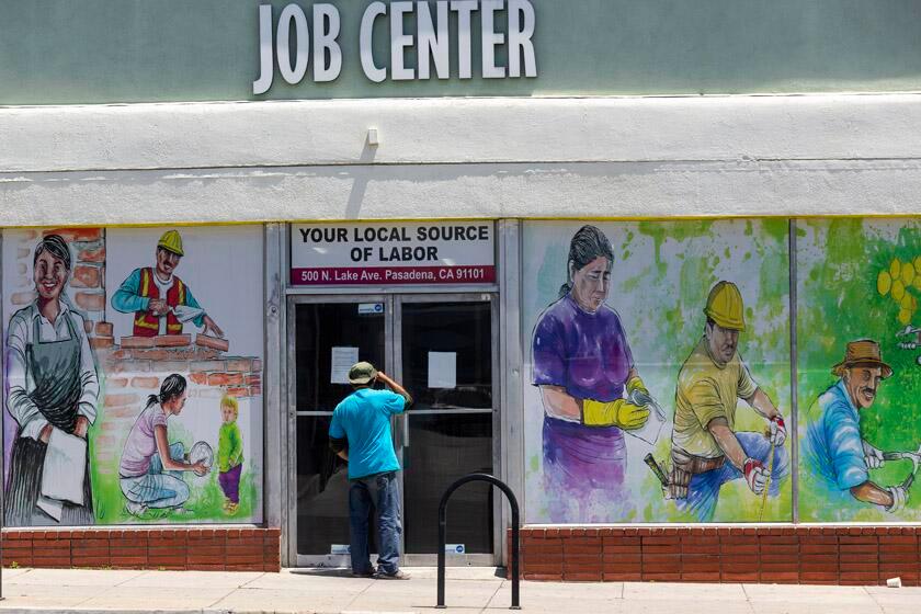 A man peers inside the the Pasadena Community Job Center in July.