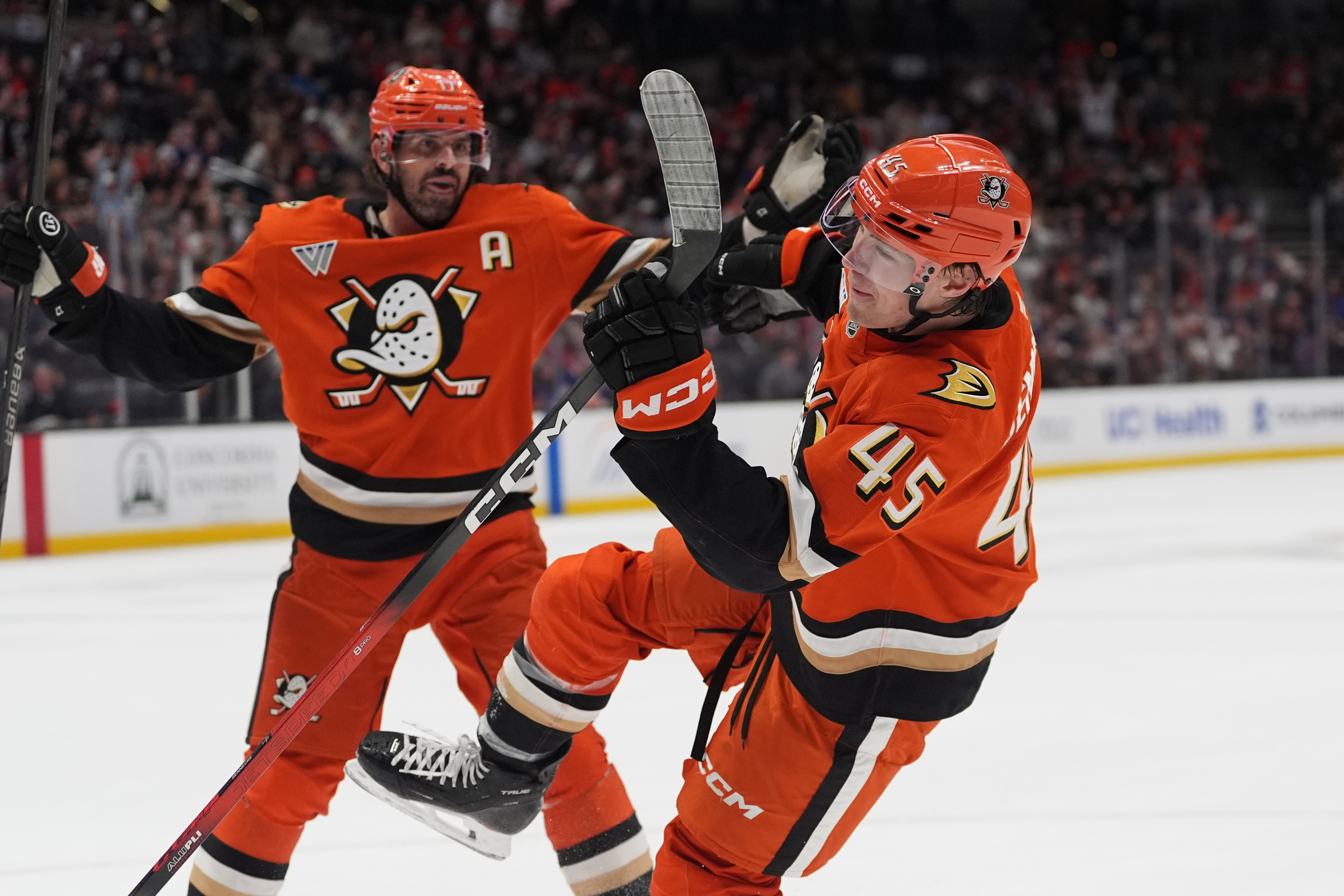Ducks right wing Beckett Sennecke, right, celebrates his goal with...
