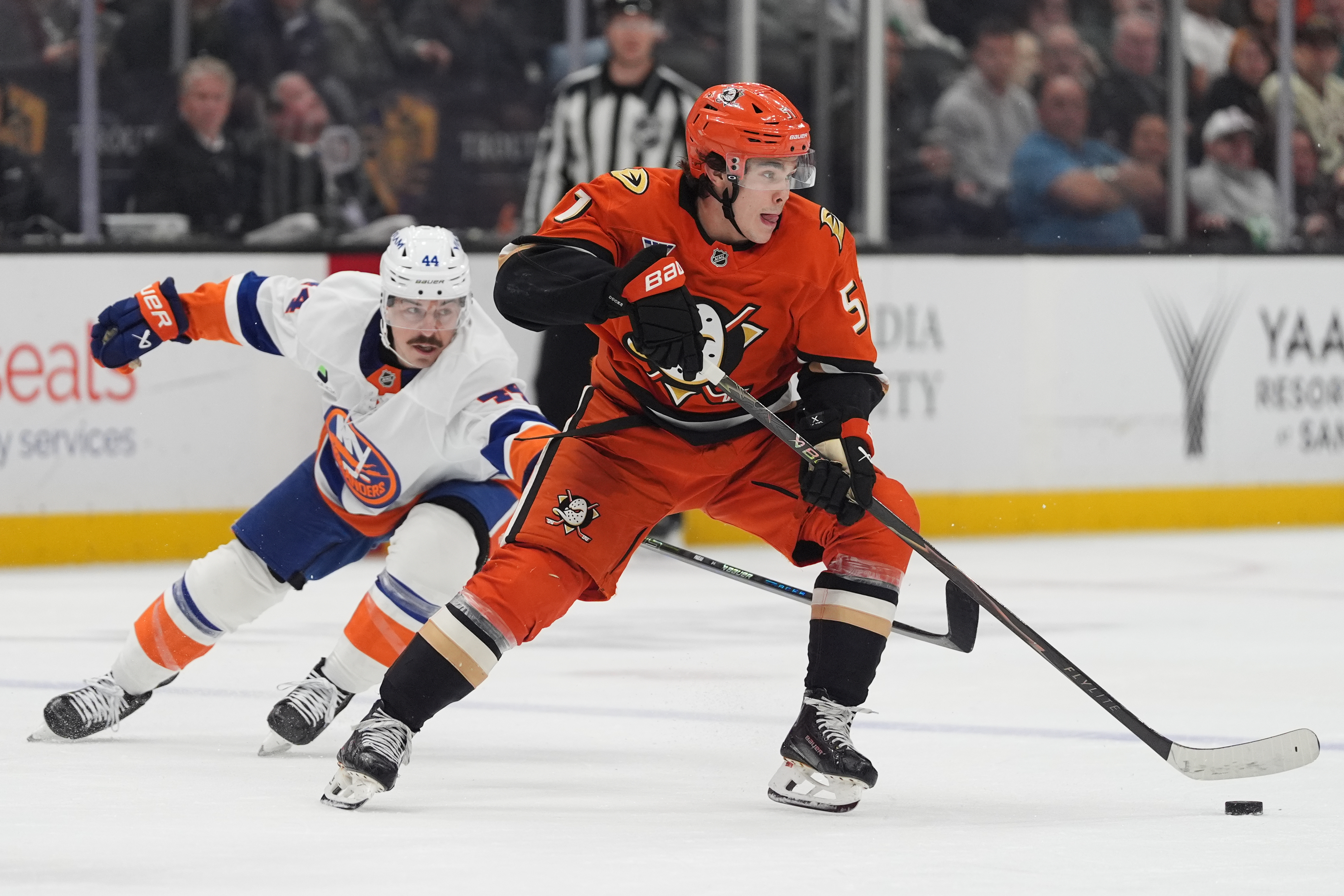 Ducks defenseman Olen Zellweger, right, looks to pass as New...