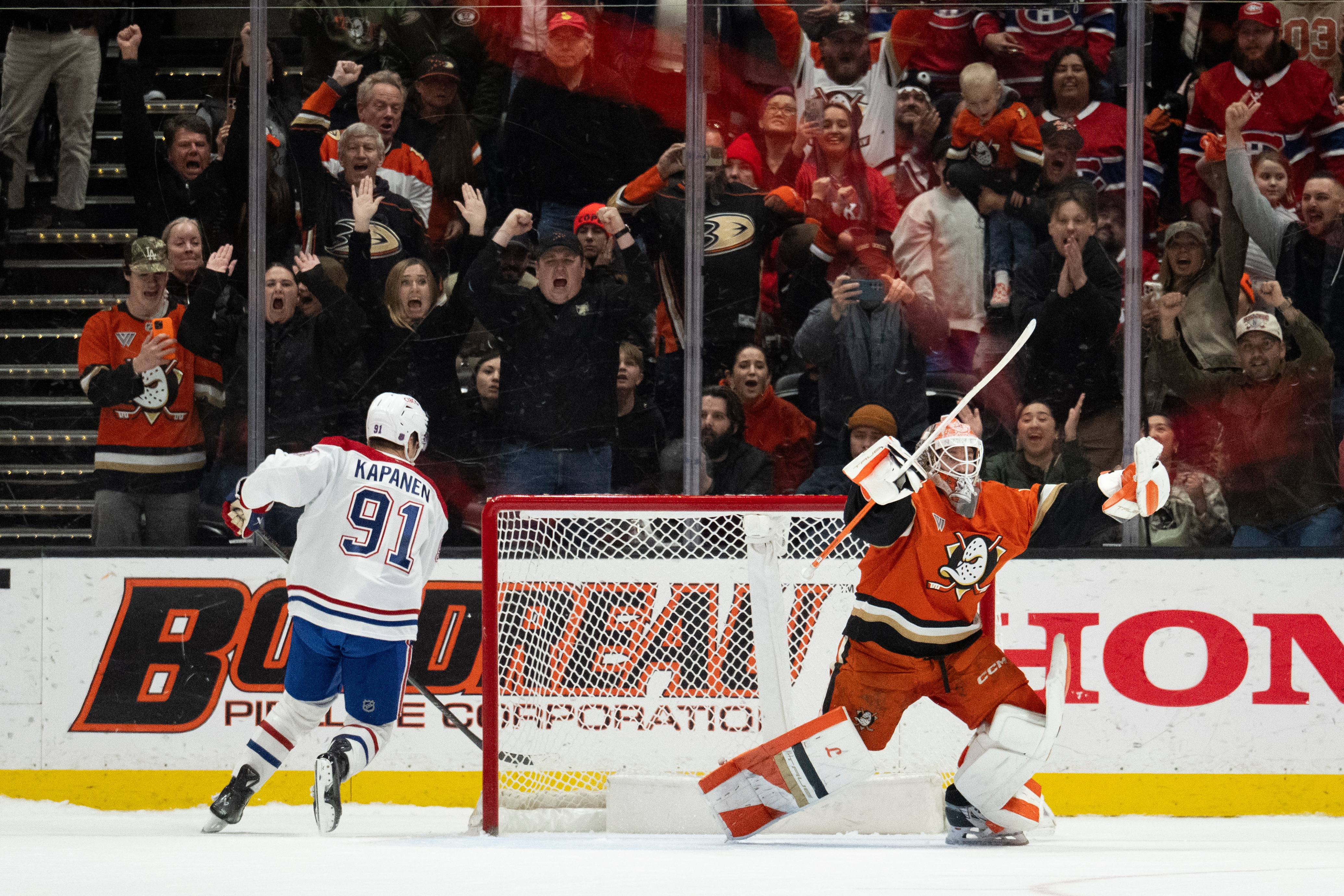 Ducks goaltender Lukas Dostal, right, reacts after blocking a shot...