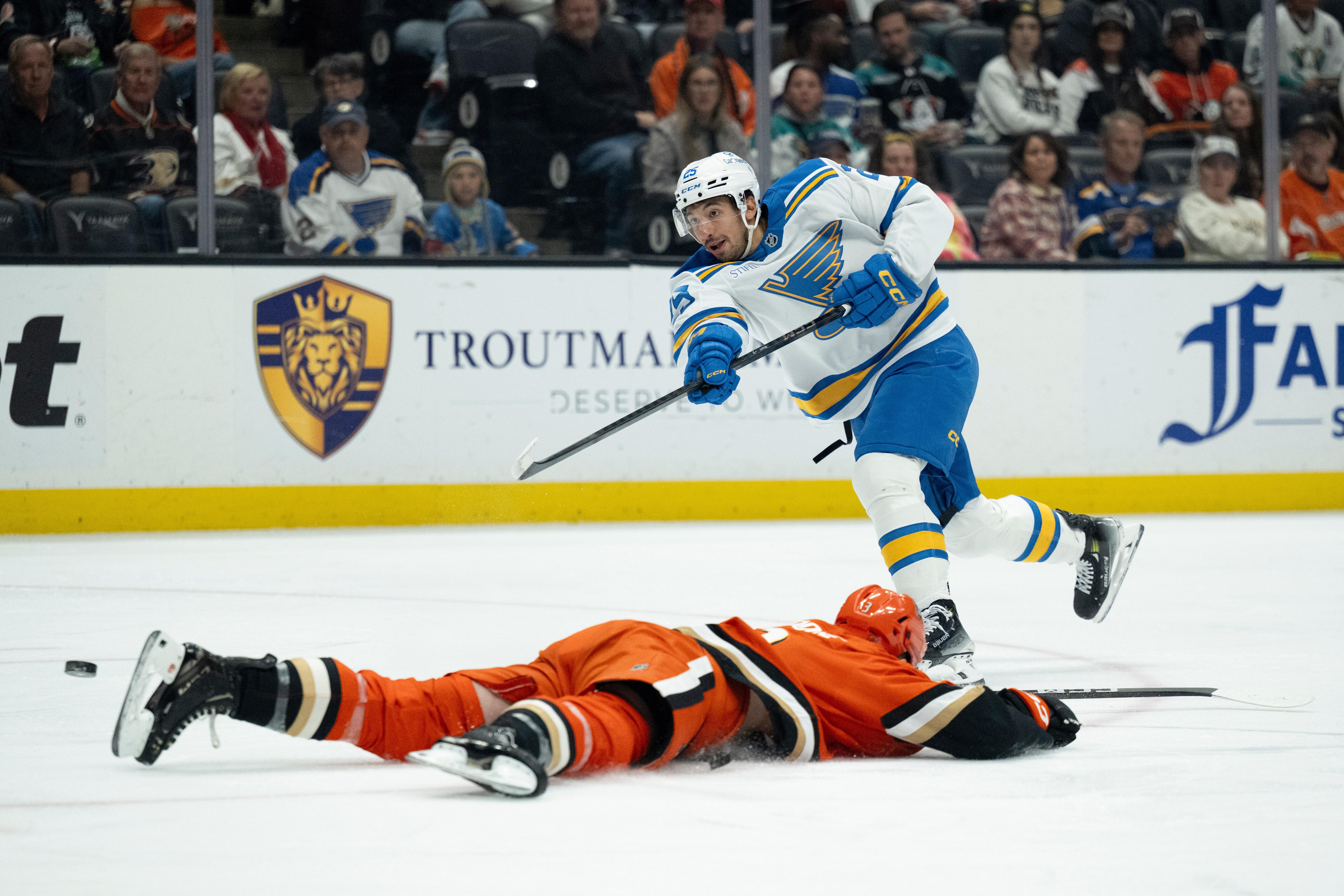 St. Louis Blues right wing Jordan Kyrou, top, shoots to...