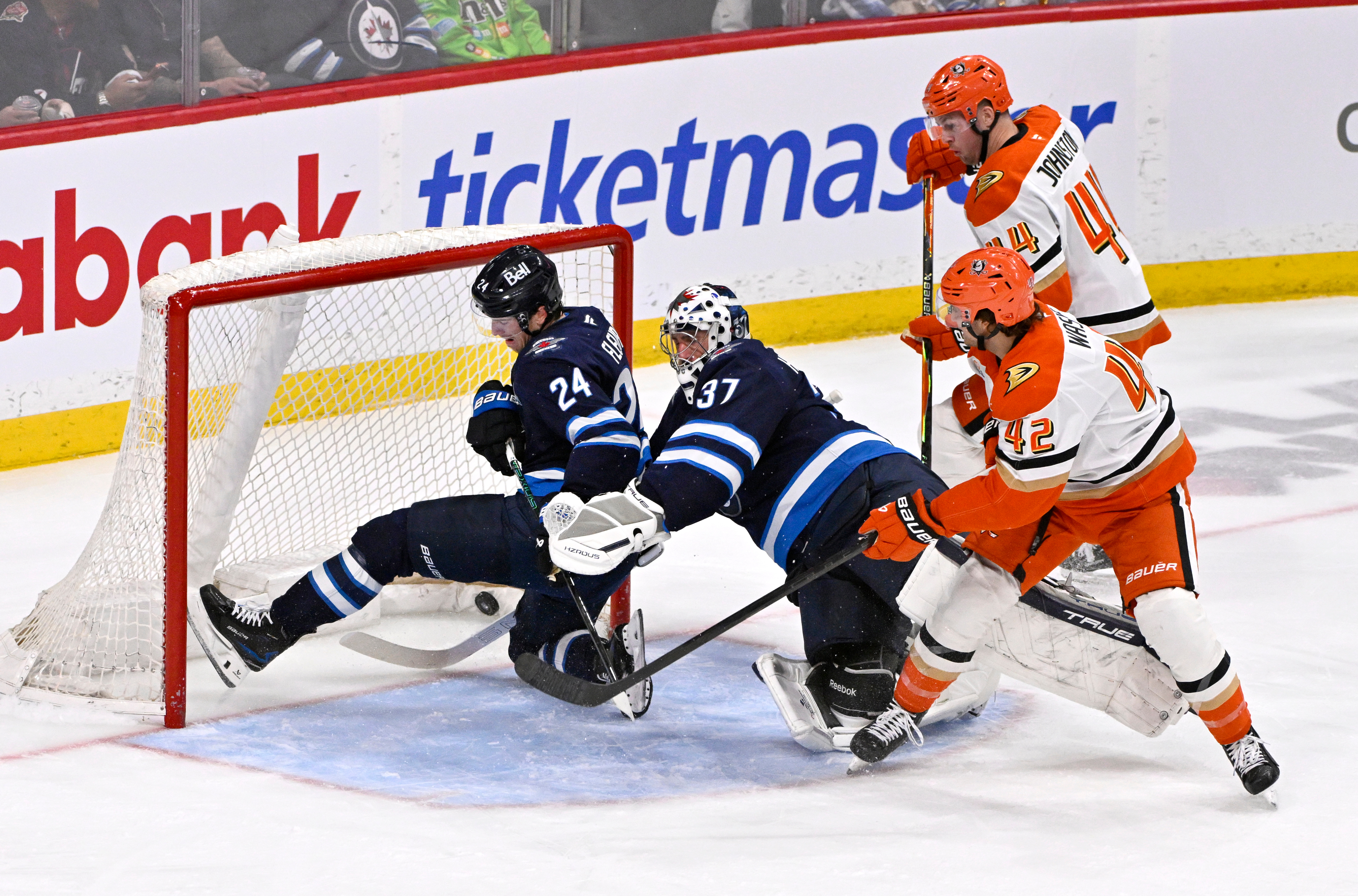 The Ducks’ Tim Washe (42) scores past Winnipeg Jets goaltender...