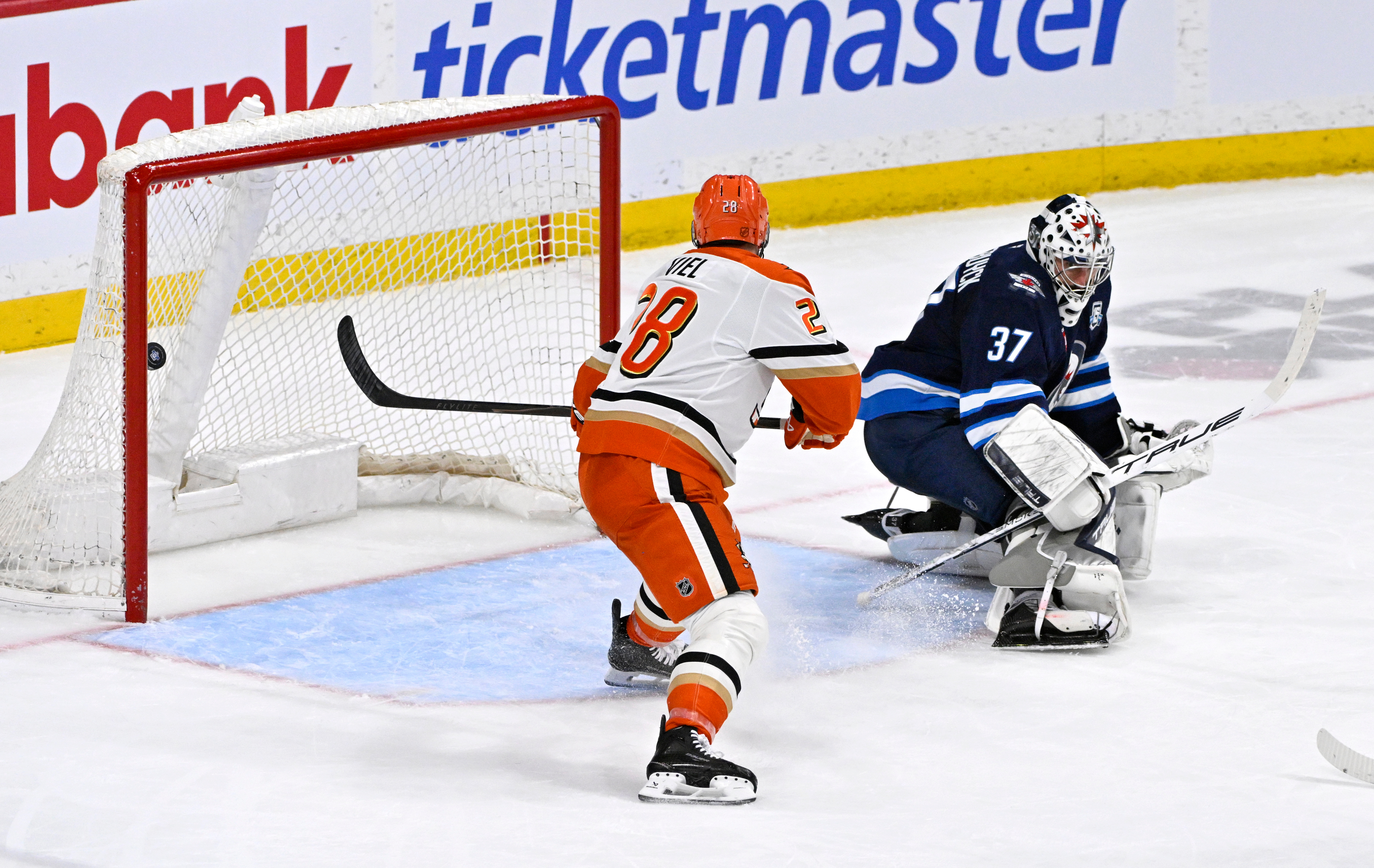 The Ducks’ Jeffrey Viel, left, scores past00 Winnipeg Jets goaltender...