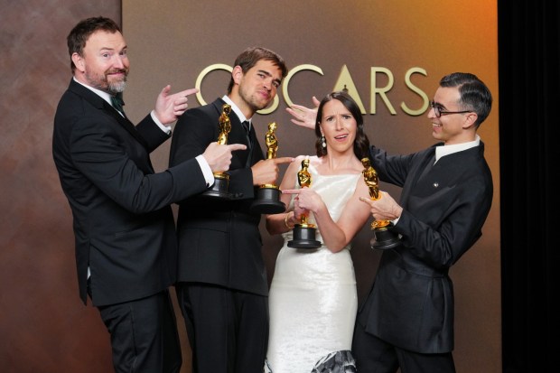 Jack Piatt, far left, and Sam A. Davis, center left, winners of the award for live action short film for "The Singers," and Natalie Musteata, center right, and Alexandre Singh, far right, winners of the award for live action short film for "Two People Exchanging Saliva," pose in the press room after tying in the category for live action short film at the Oscars on Sunday, March 15, 2026, at the Dolby Theatre in Los Angeles. (Photo by Jordan Strauss/Invision/AP)