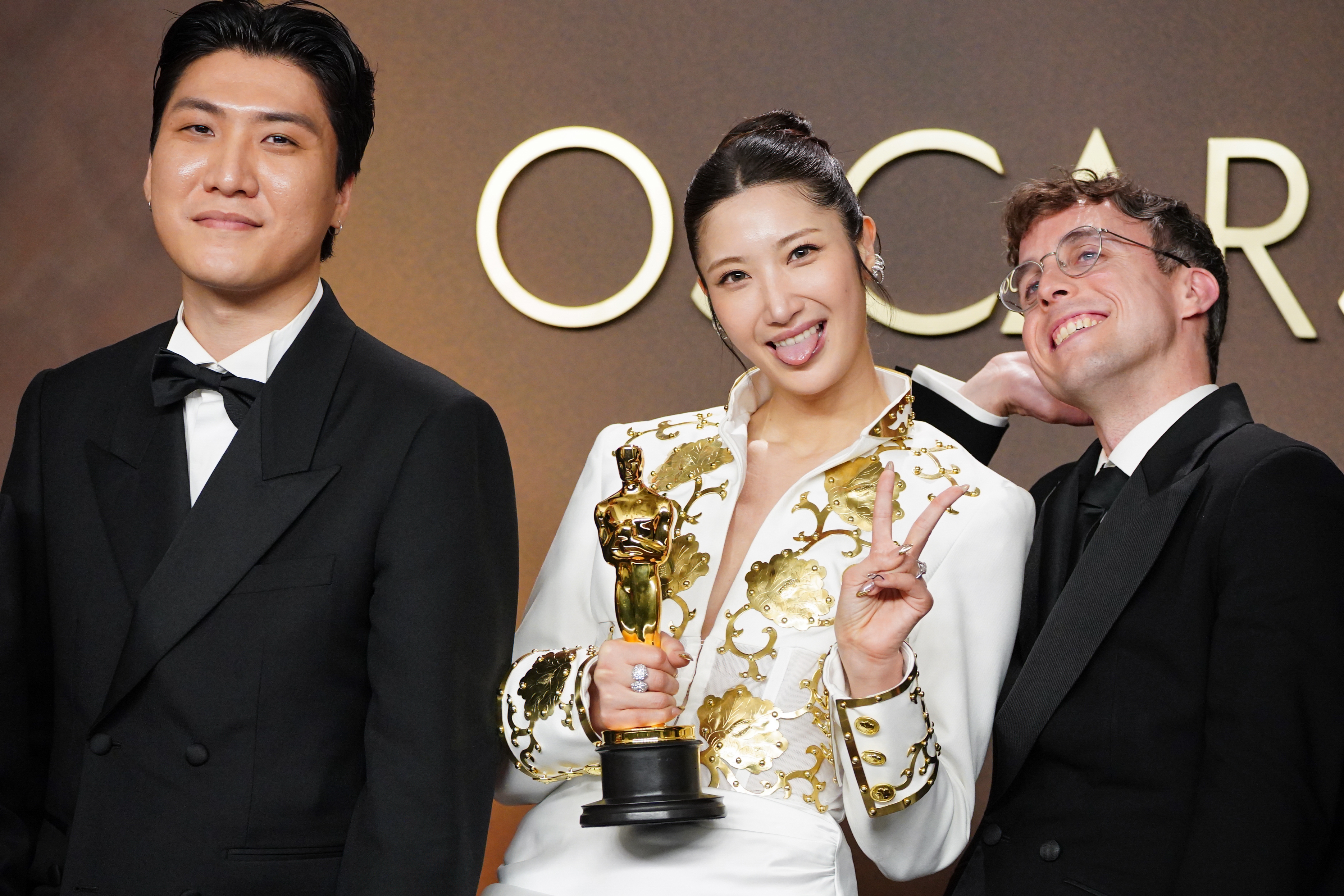 Joong Gyu Kwak, from left, EJAE, and Mark Sonnenblick, winners of the award for music (original song) for “Golden” from “K-pop Demon Hunters,” pose in the press room at the Oscars on Sunday, March 15, 2026, at the Dolby Theatre in Los Angeles. (Photo by Jordan Strauss/Invision/AP)
