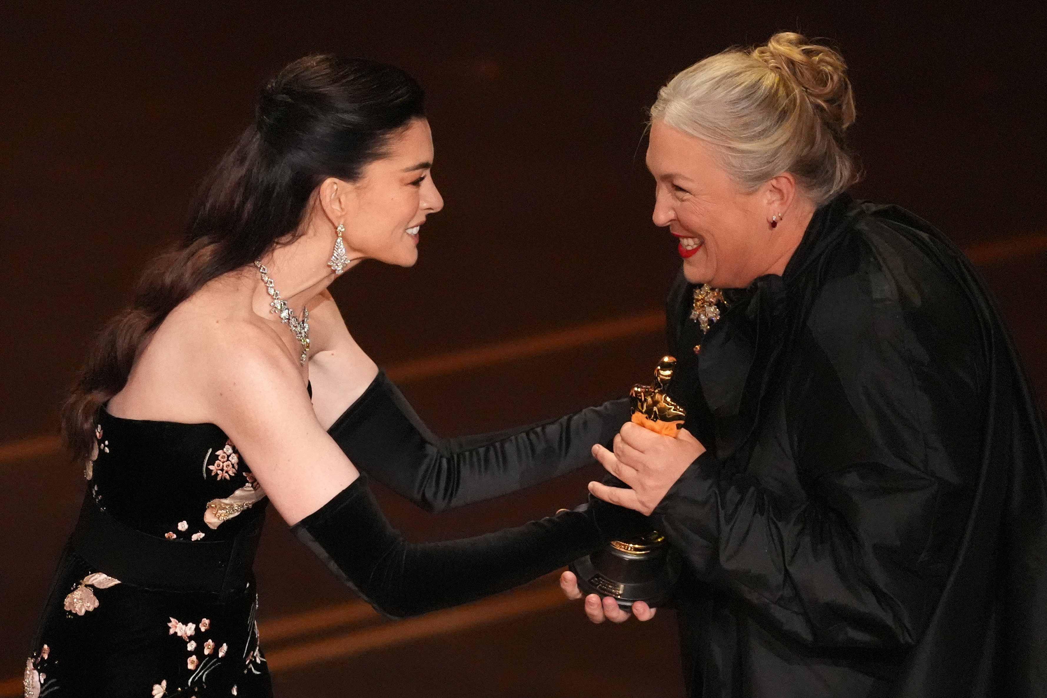Anne Hathaway presents the award for best costume design to Kate Hawley for “Frankenstein” during the Oscars on Sunday, March 15, 2026, at the Dolby Theatre in Los Angeles. (AP Photo/Chris Pizzello)