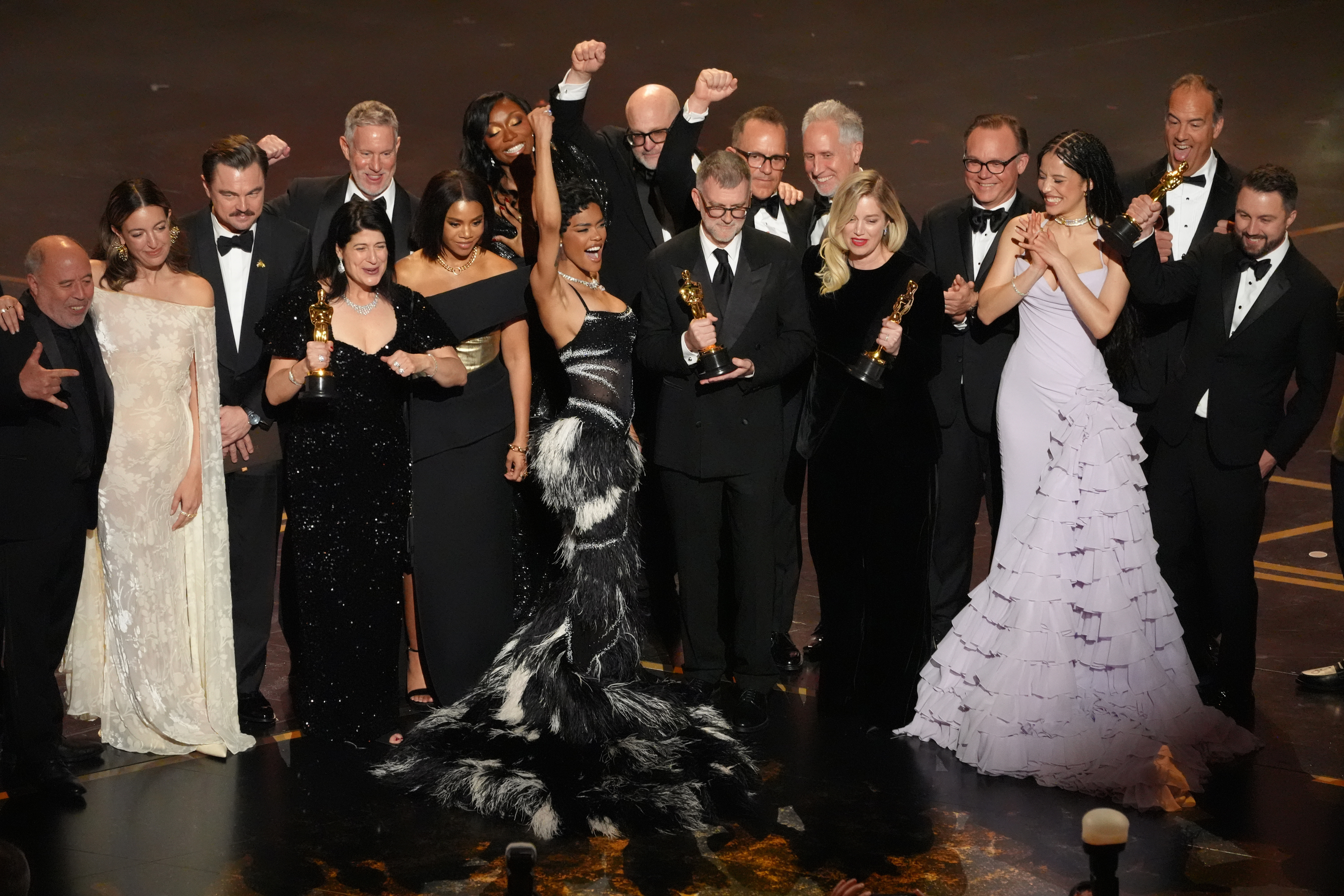 Jose Antonio Garcia, from left, Florencia Martin, Leonardo DiCaprio, Cassandra Kulukundis, Regina Hall, Shayna McHale, Teyana Taylor, Michael Bauman, Paul Thomas Anderson, Anthony Carlino, Will Weike, Sara Murphy, Chase Infiniti, Christopher Scarabosio, and Andy Jurgensen accept the award for best picture award for “One Battle After Another” during the Oscars on Sunday, March 15, 2026, at the Dolby Theatre in Los Angeles. (AP Photo/Chris Pizzello)