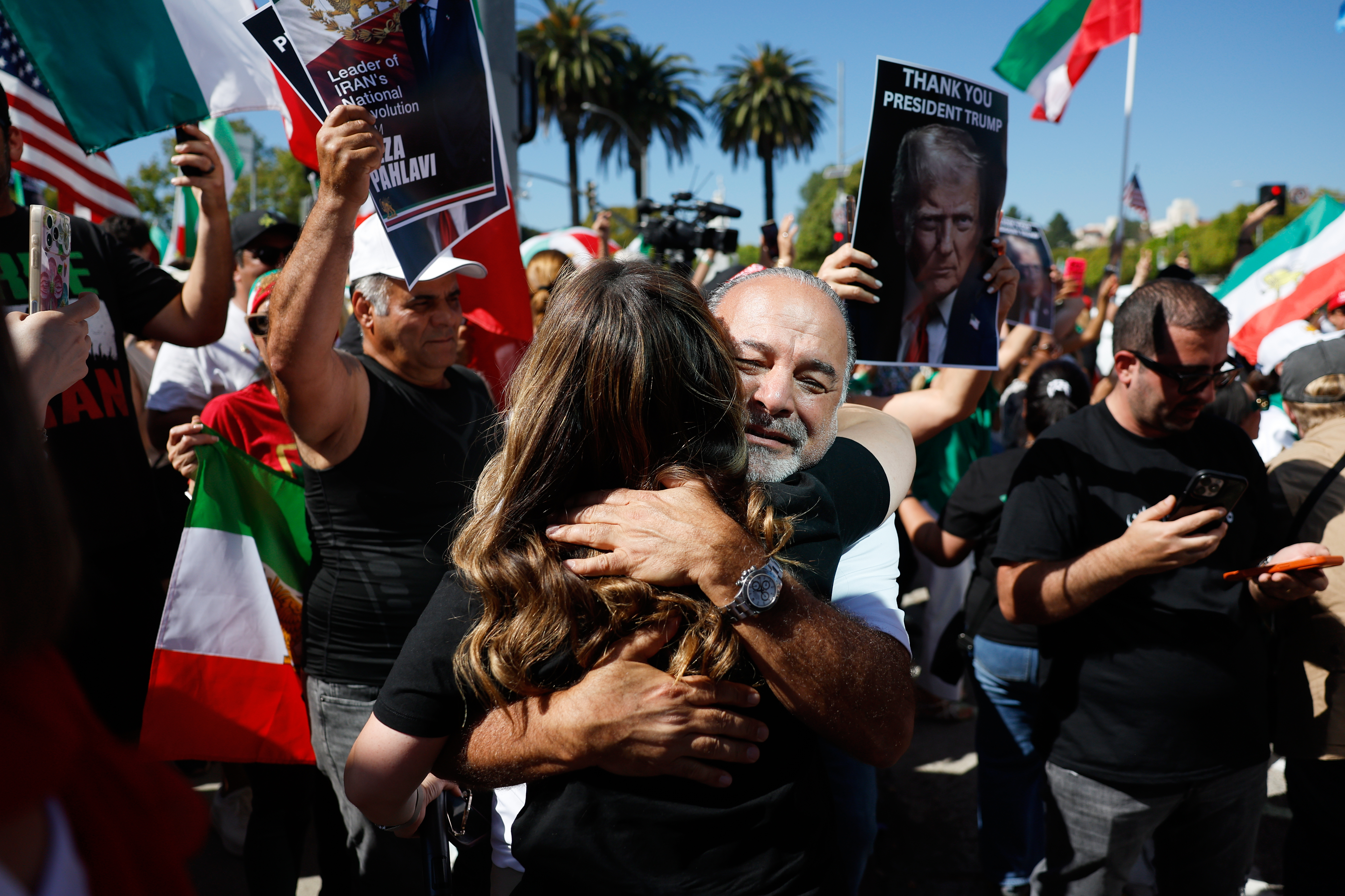 Demonstrators hug as they march in reaction to the U.S....