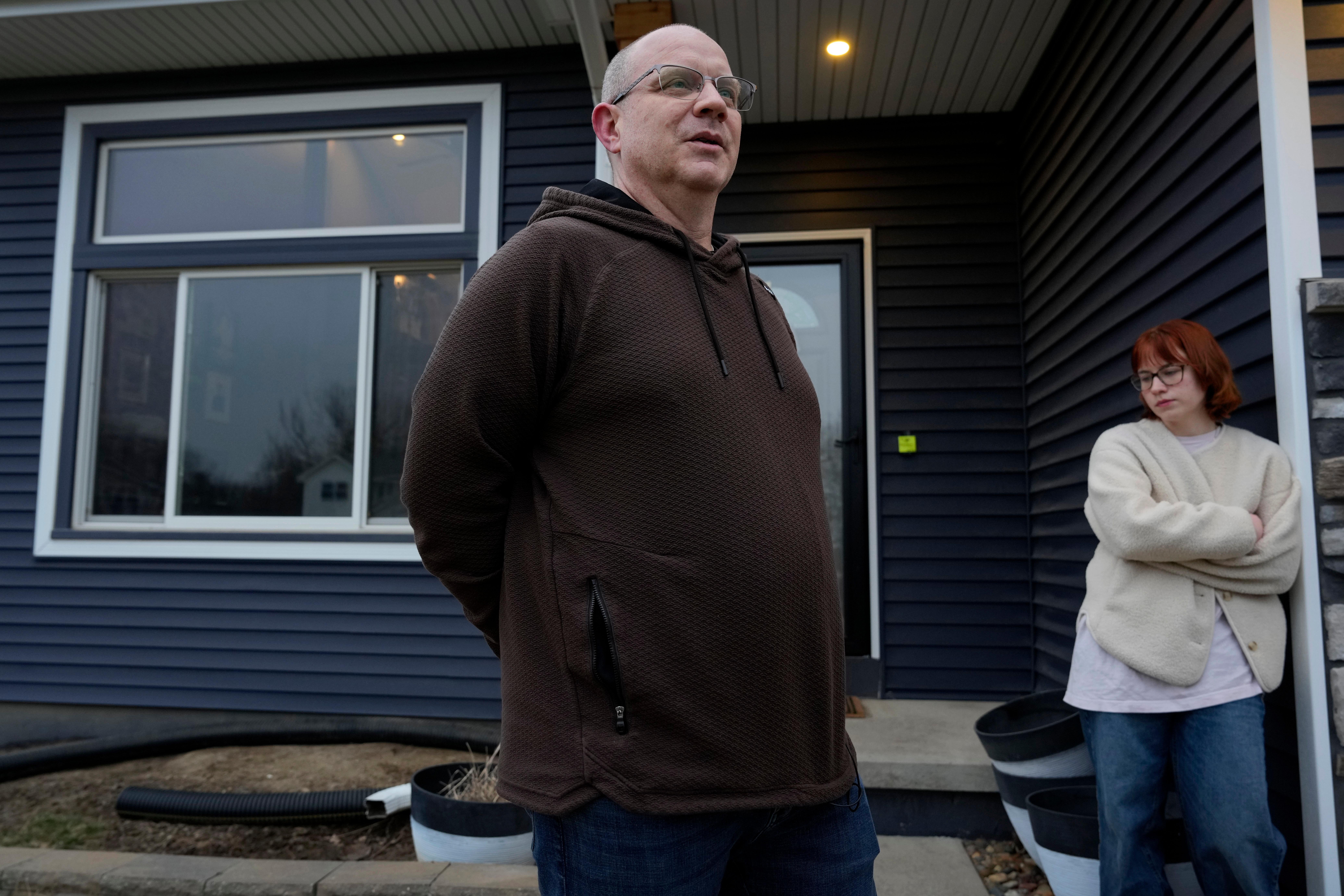 Andrew Coady and his daughter Keira outside their home.