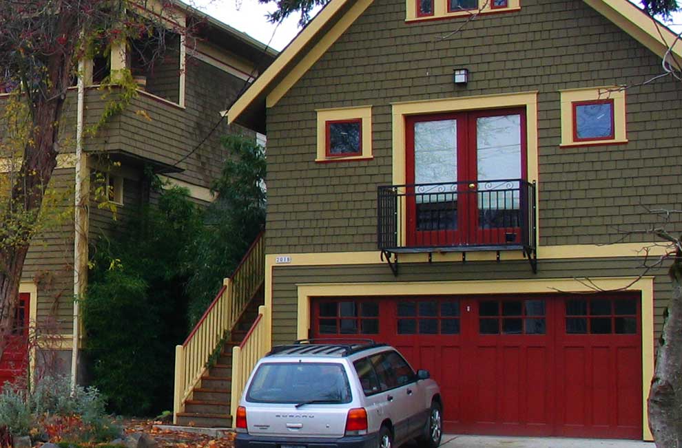 A room above the garage with a car parked outside