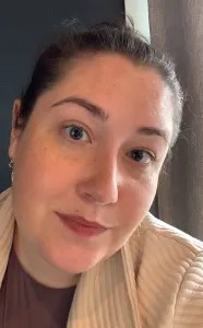A close-up headshot of a woman with her hair pulled up.