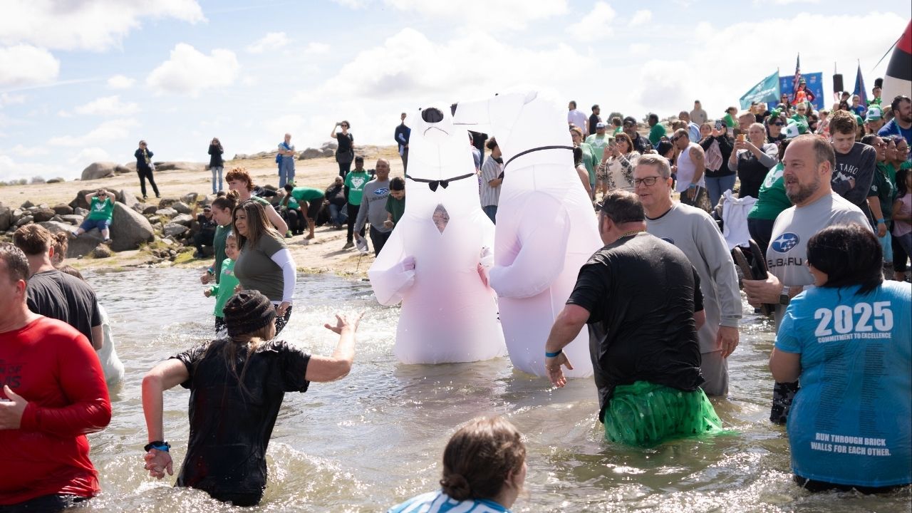 Attendees, some dressed as inflatable bears, jump into Millerton Lake during the 2025 Fresno Polar Plunge. (Northern California Special Olympics)