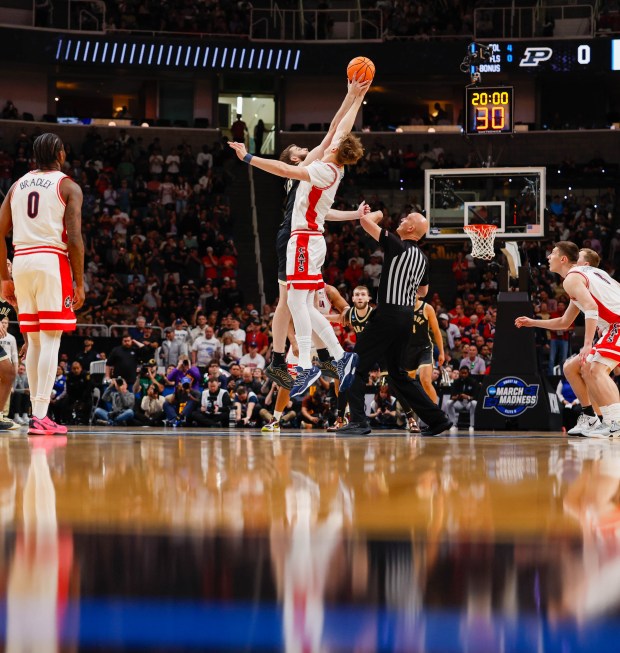 Arizona Wildcats' Motiejus Krivas (13) and Purdue Boilermakers' Oscar Cluff (45) jump for the ball in the first half during the NCAA Tournament West Regional final at the SAP Center in San Jose, Calif., on Saturday, March 28, 2026.  (Shae Hammond/Bay Area News Group)