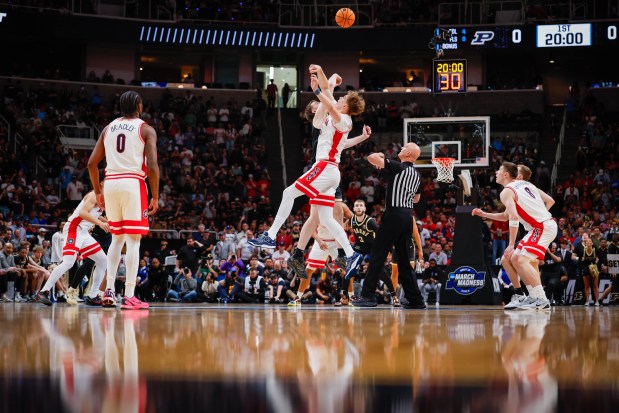 Arizona Wildcats' Motiejus Krivas (13) and Purdue Boilermakers' Oscar Cluff (45) jump for the ball in the first half during the NCAA Tournament West Regional final at the SAP Center in San Jose, Calif., on Saturday, March 28, 2026.  (Shae Hammond/Bay Area News Group)