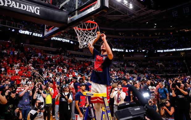 Arizona Wildcats' Brayden Burries (5) cuts the net after Arizona Wildcats win against Purdue Boilermakers during the NCAA Tournament West Regional final at the SAP Center in San Jose, Calif., on Saturday, March 28, 2026.  (Shae Hammond/Bay Area News Group)