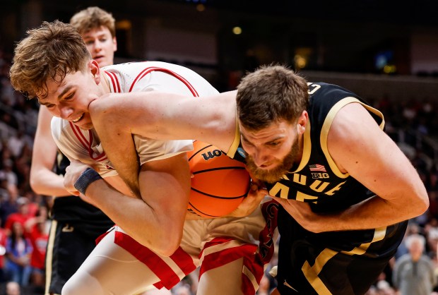 Arizona Wildcats' Motiejus Krivas (13) is elbowed in the face by Purdue Boilermakers' Oscar Cluff (45) while fighting for the ball in the second half during the NCAA Tournament West Regional final at the SAP Center in San Jose, Calif., on Saturday, March 28, 2026.  (Shae Hammond/Bay Area News Group)