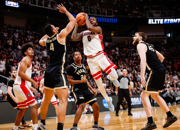 Arizona Wildcats' Jaden Bradley (0) takes a shot against Purdue Boilermakers' Trey Kaufman-Renn (4) and Purdue Boilermakers' Oscar Cluff (45) in the second half during the NCAA Tournament West Regional final at the SAP Center in San Jose, Calif., on Saturday, March 28, 2026.  (Shae Hammond/Bay Area News Group)