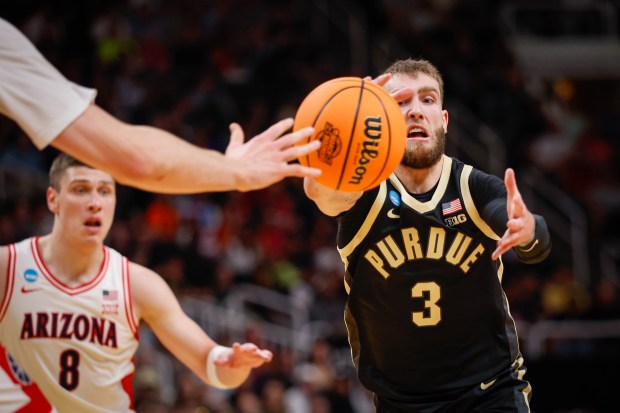 Purdue Boilermakers' Braden Smith (3) reaches for the ball against Arizona Wildcats' Ivan Kharchenkov (8) in the first half during the NCAA Tournament West Regional final at the SAP Center in San Jose, Calif., on Saturday, March 28, 2026.  (Shae Hammond/Bay Area News Group)
