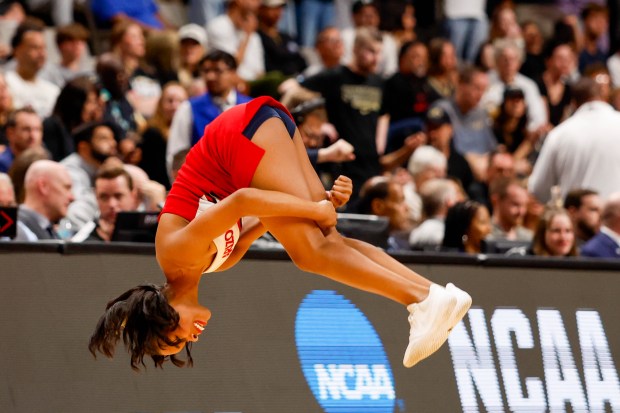 An Arizona Wildcats cheerleader does a flip in the first half during the NCAA Tournament West Regional final at the SAP Center in San Jose, Calif., on Saturday, March 28, 2026.  (Shae Hammond/Bay Area News Group)