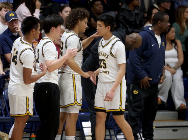 The King's Academy's Nathan Hong (25) is congratulated by teammates including Scotty Beamish Jr., (22) left, in the fourth quarter of their NorCal Division 1 semifinal game against Oakland High at The King's Academy in Sunnyvale, Calif., on Saturday, March 7, 2026. The senior it three straight 3's to give TKA a 33-24 lead at halftime. (Jane Tyska/Bay Area News Group)