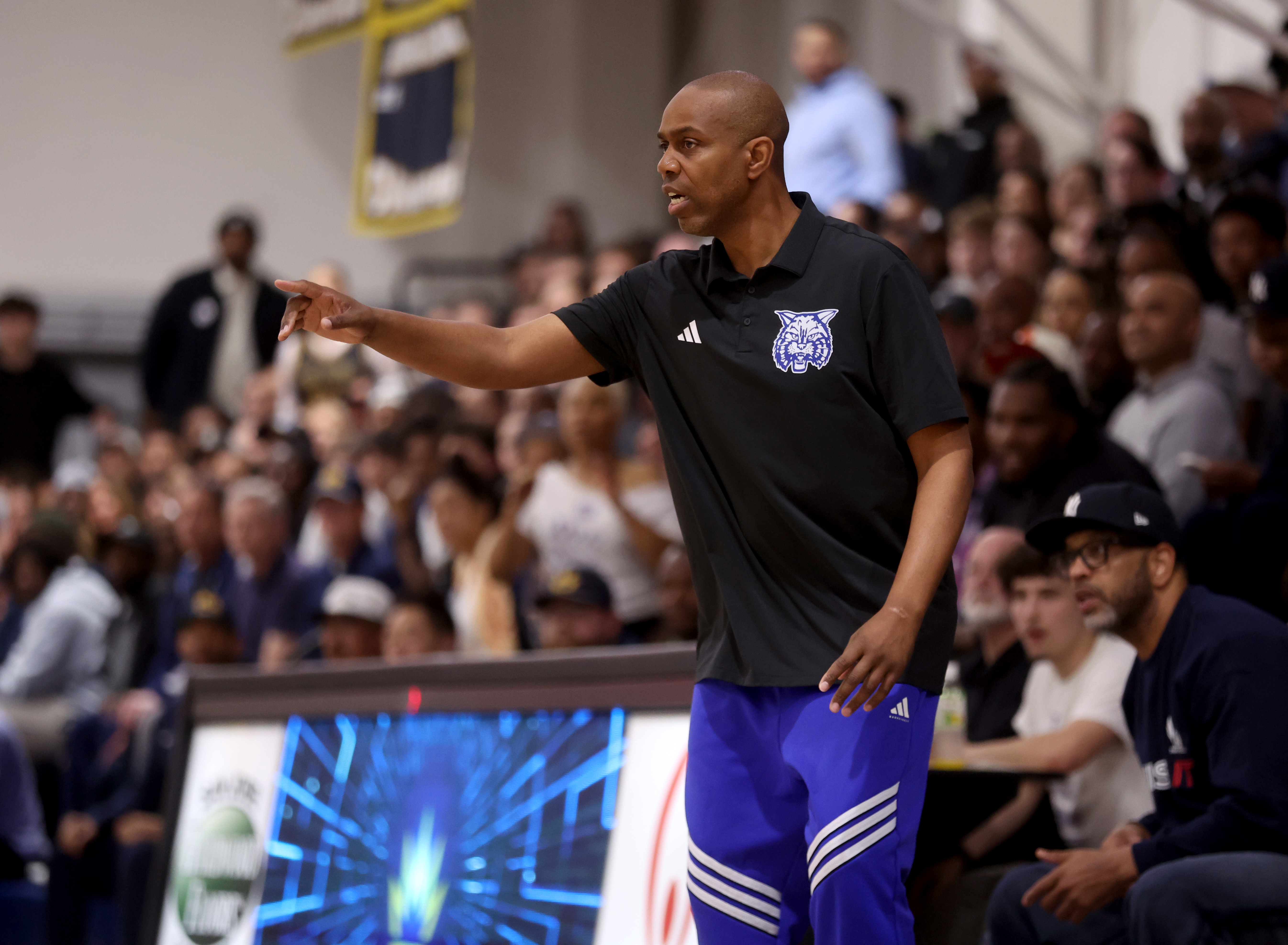 Oakland High head coach Orlando Watkins gestures from sideline in...