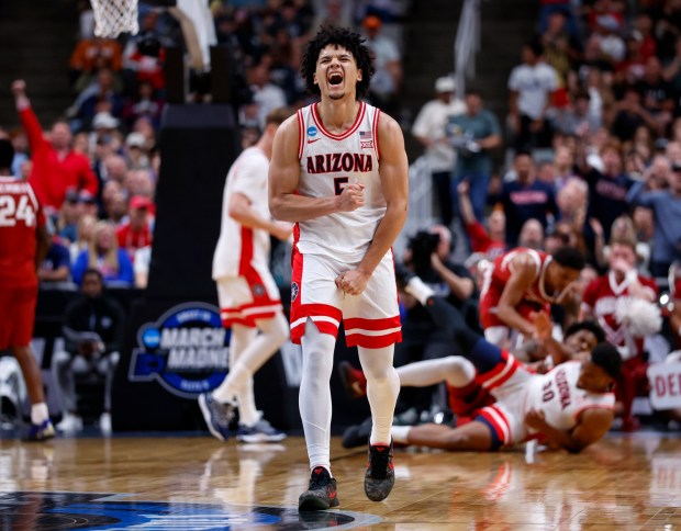 Arizona Wildcats' Brayden Burries (5) celebrates a basket and a foul by a teammate against the Arkansas Razorbacks in the first half at the 2026 NCAA Division I West Regional Semifinal game at the SAP Center in San Jose, Calif., on Thursday, March 26, 2026. (Nhat V. Meyer/Bay Area News Group)